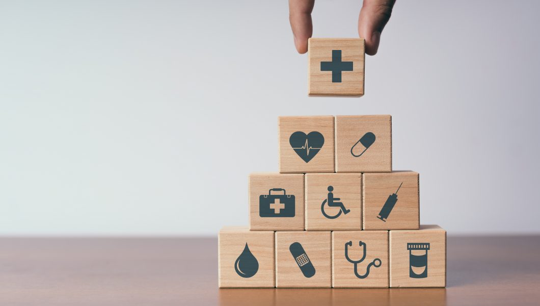 Concept of Insurance for your health, Hand hold wooden block wit