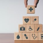 Concept of Insurance for your health, Hand hold wooden block wit