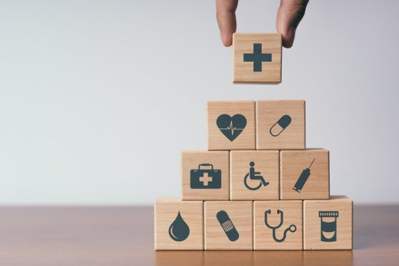 Concept of Insurance for your health, Hand hold wooden block wit